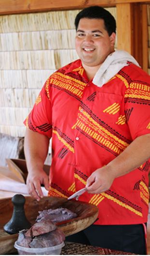 Volunteer Spencer Mauai helps make fresh poi in the PCC’s Hawaiian Village