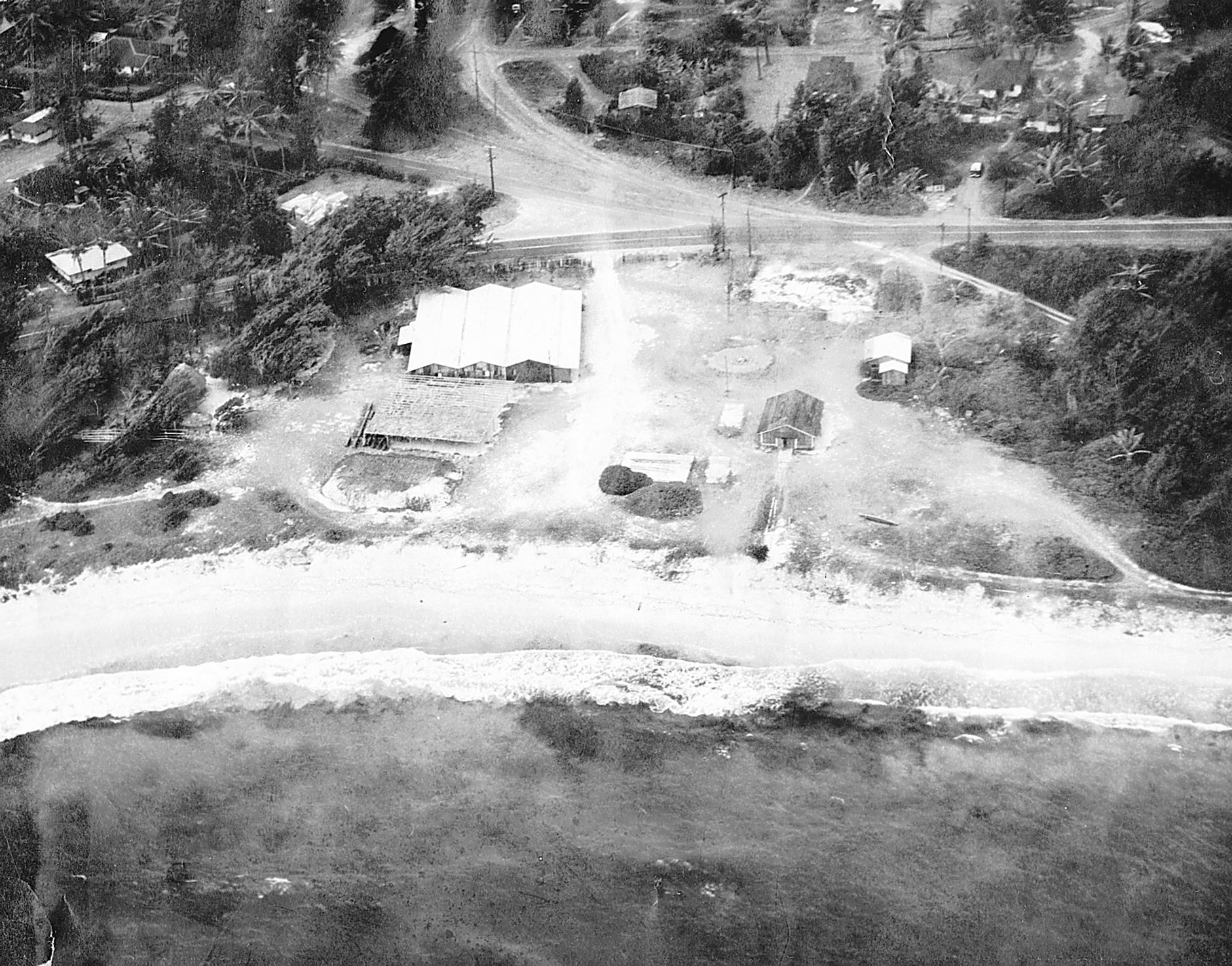 Laie Beach (later named Hukilau Beach) showing the bakery, the various boat houses and Kamehameha Hwy. Courtesy of BYUH Archives and Special Collections