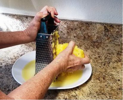 Pineapple being grated