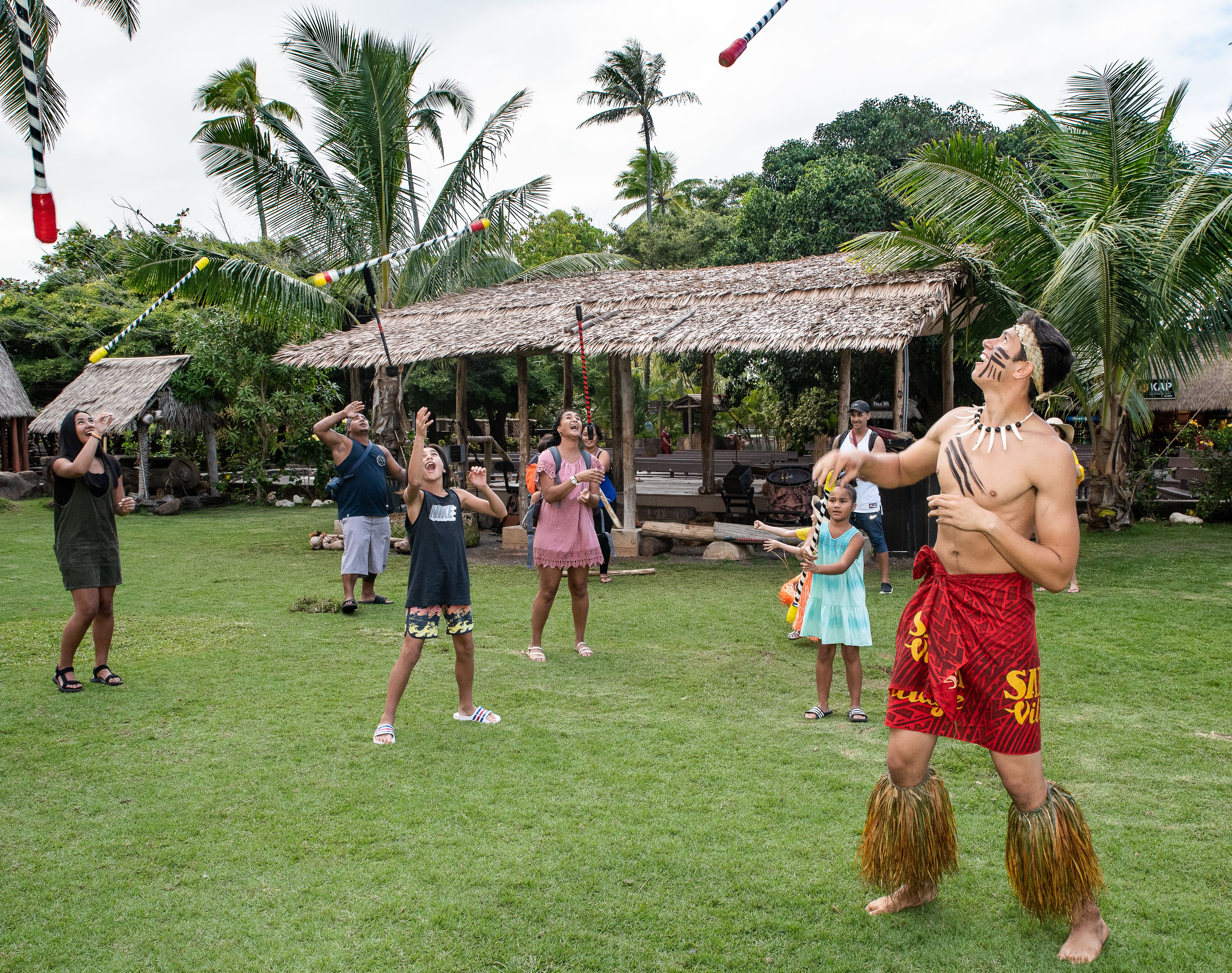 photo of guests and Samoan villager tossing 'fireknives'