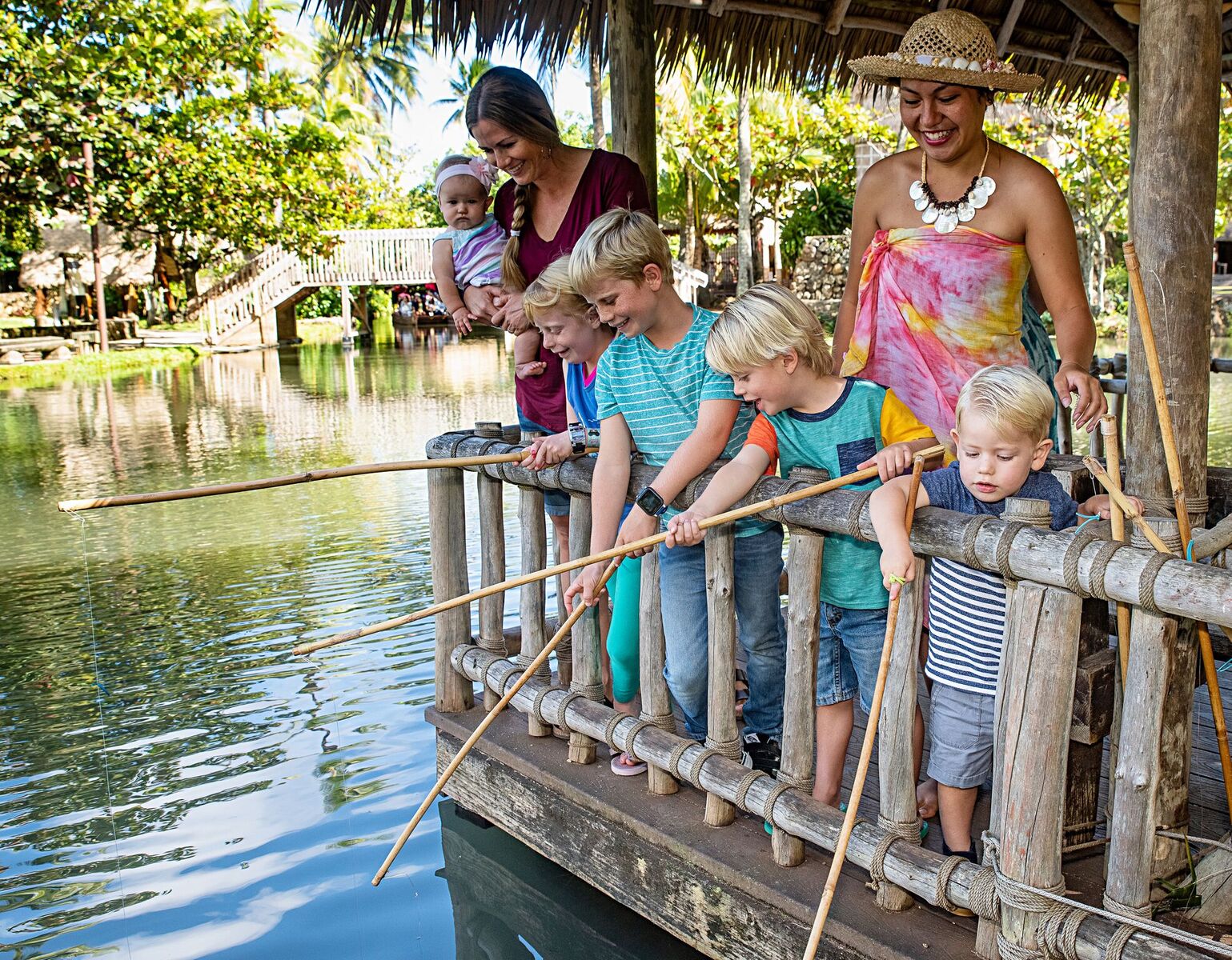 Picture of family fishing at Tahiti Village at the Polynesian Cultural Center