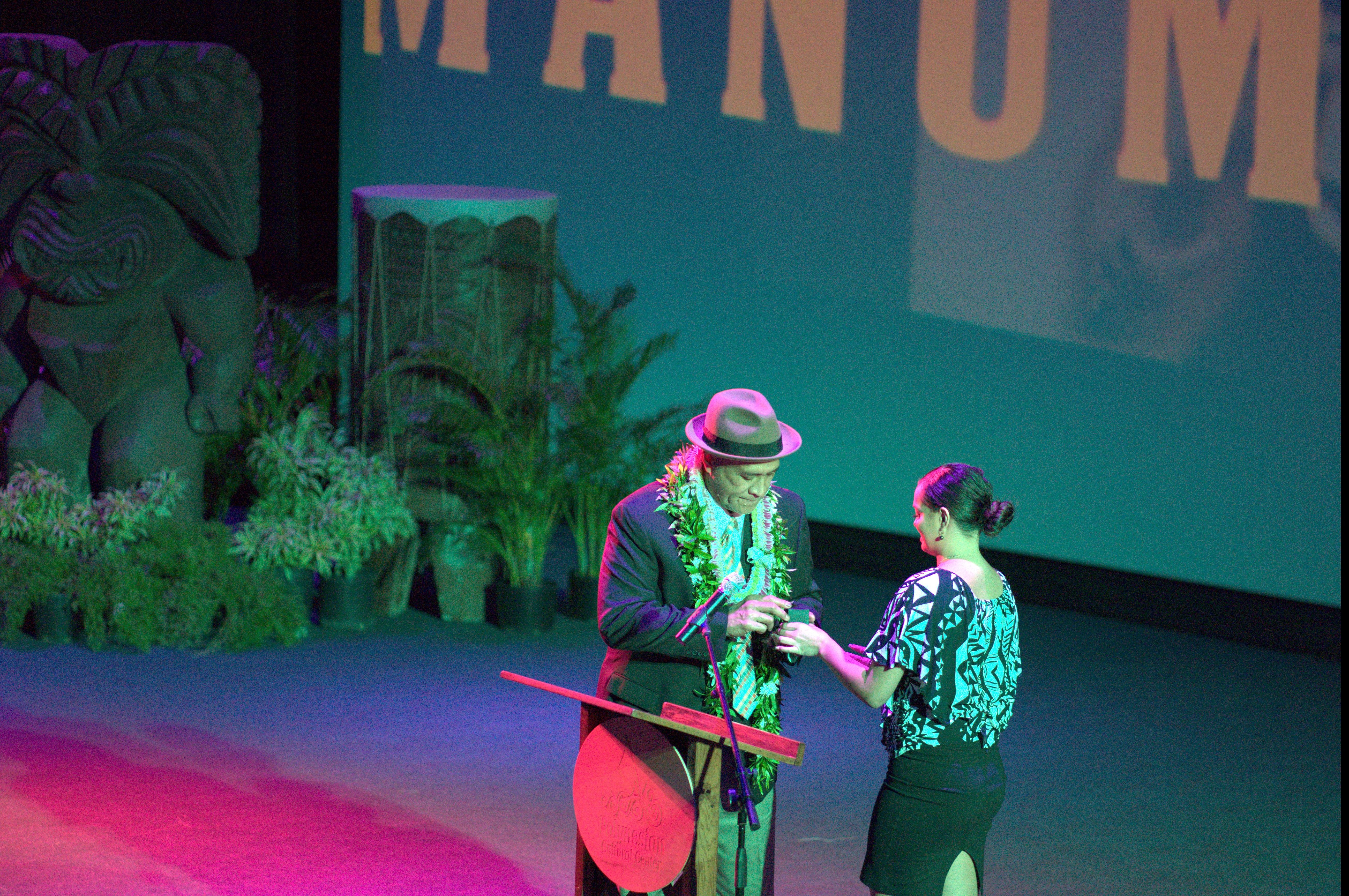 Photo of Frank Manumaluega receiving his induction ring from the Polynesian Football Hall of Fame