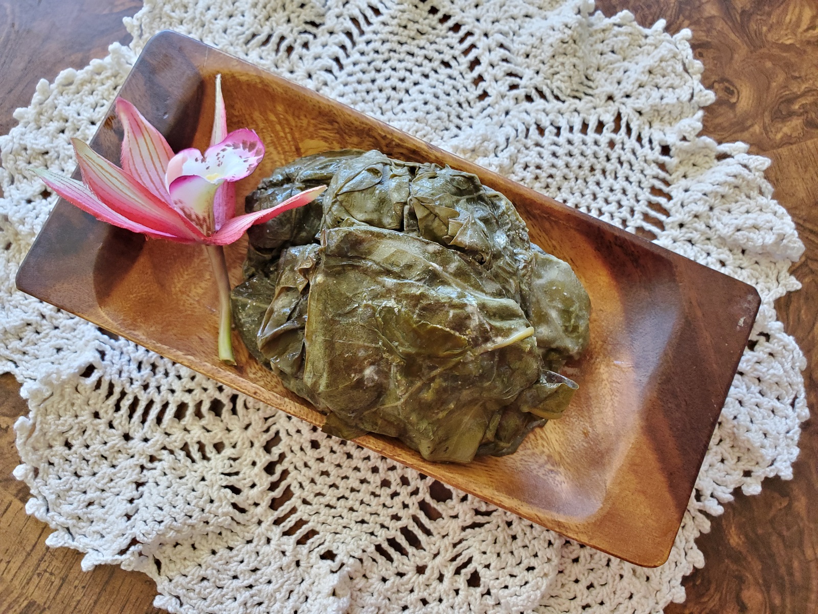 photo of palusami on a rectangle wooden plate