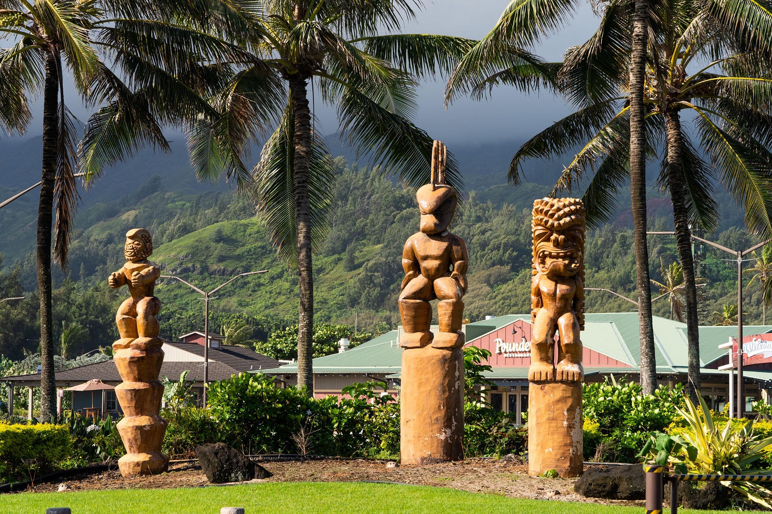Photo of three giant tikis that are placed just outside the main entrance to the Polynesian Cultural Center