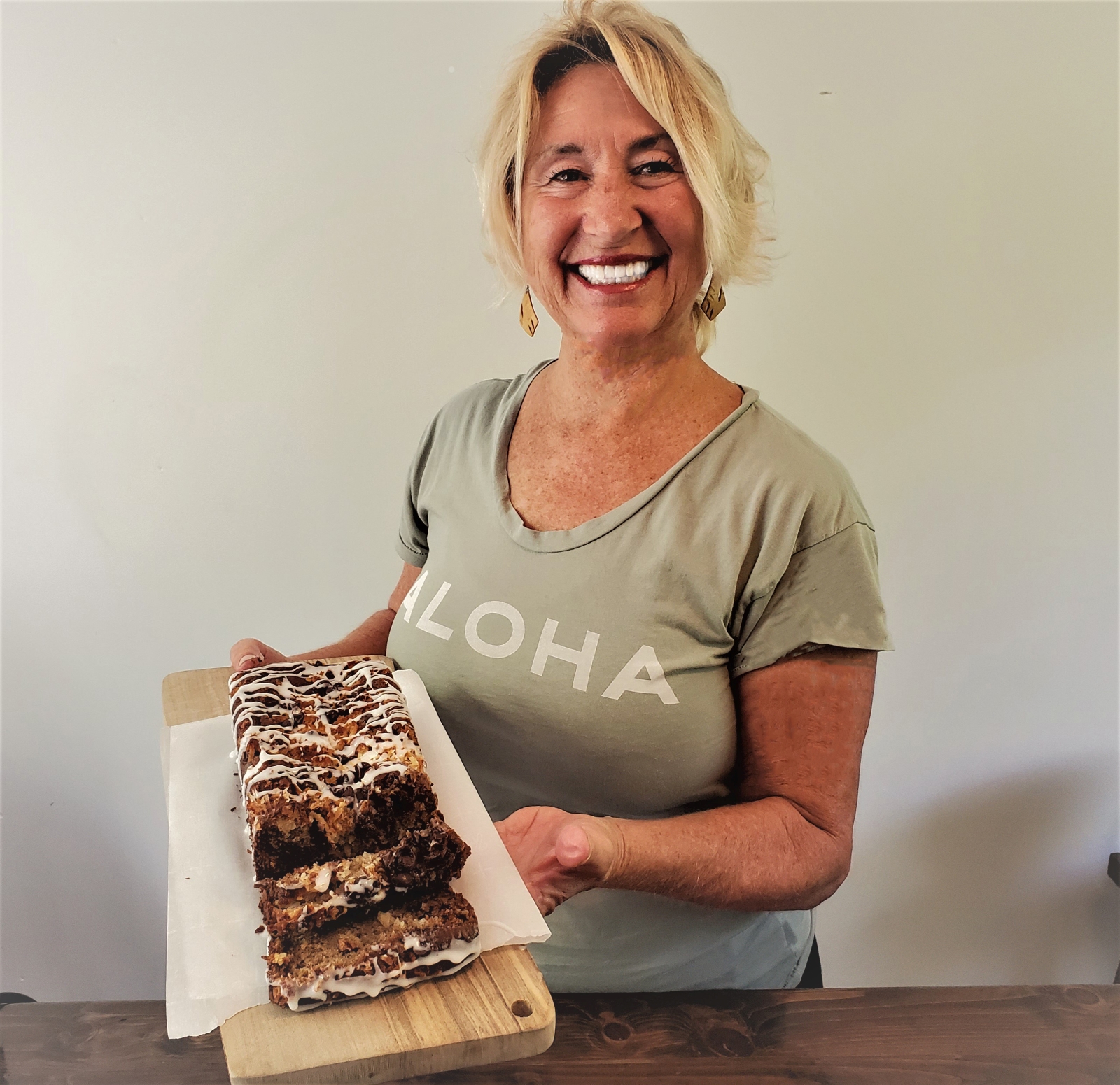 image of Peggy Hannemann with a freshly baked loaf of Tropical Banana Bread