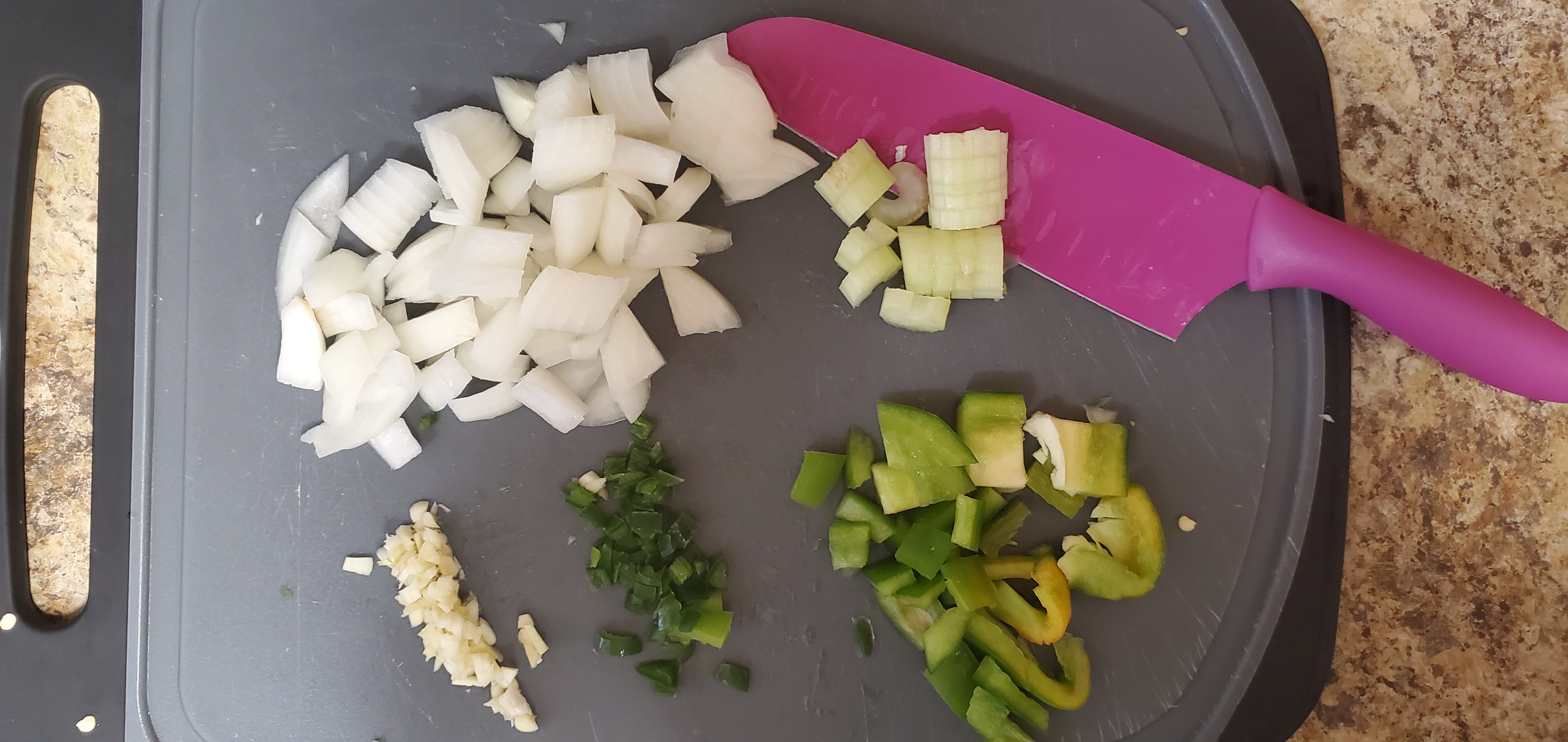 display of alternate ingredients for chicken or vegetarian roti including onions, celery, sweet peppers, cilantro, and crushed and diced ginger