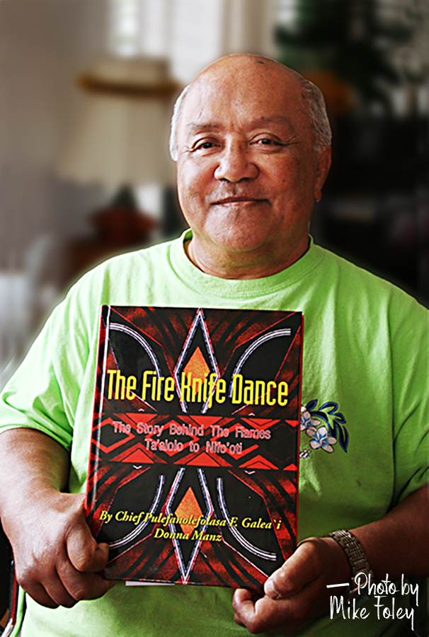 image of Pulefano Galeai holding his book The Fire Knife Dance: The Story Behind the Flames Ta'aoo to Nifo'oti