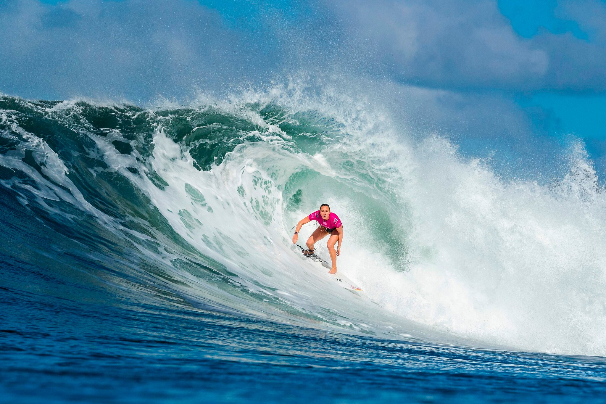 image of female surfer Carissa Moore catching a wave from her professional website