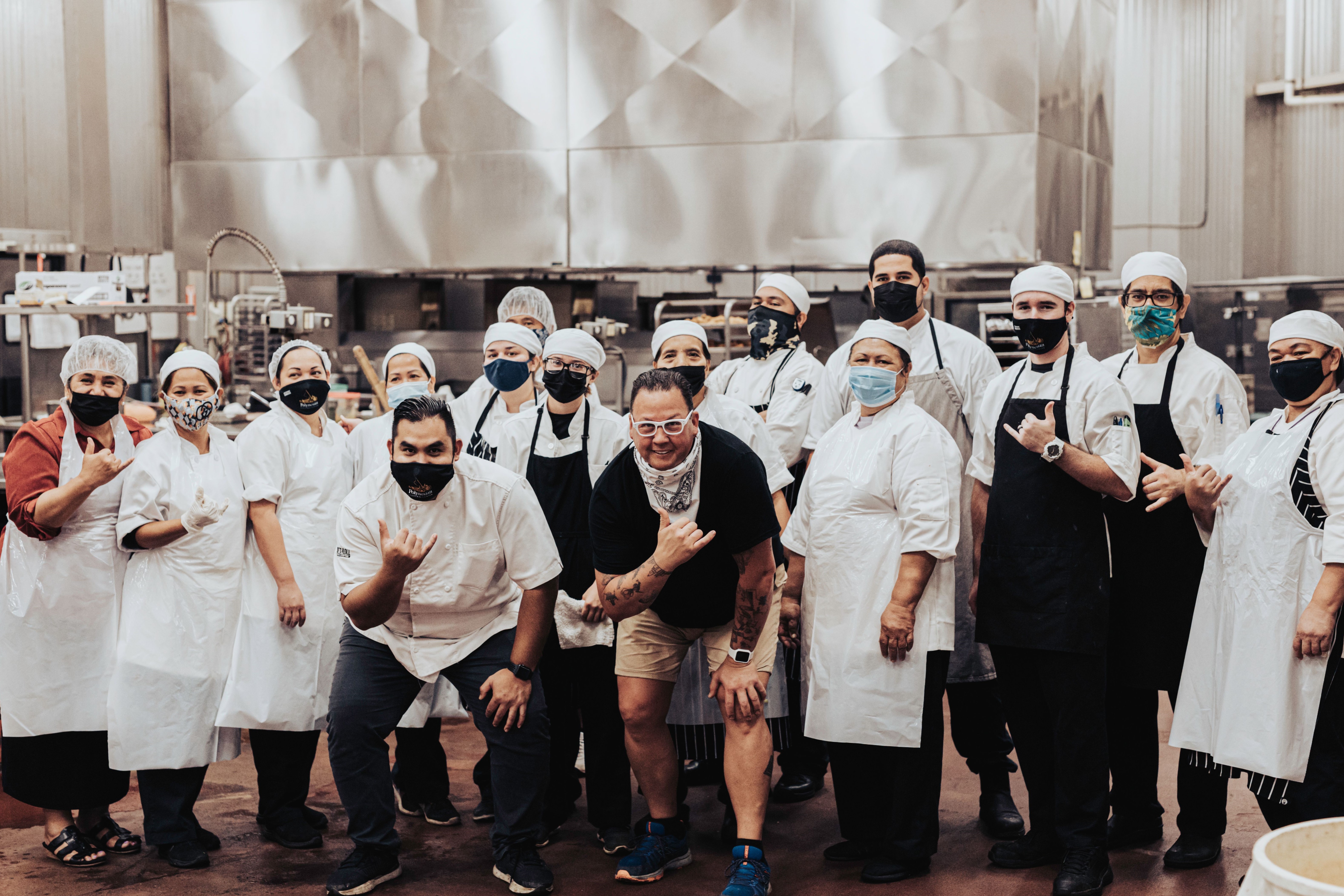 image of food services staff at the Polynesian Cultural Center pose for a 'masked' photo with Chef Graham Elliot