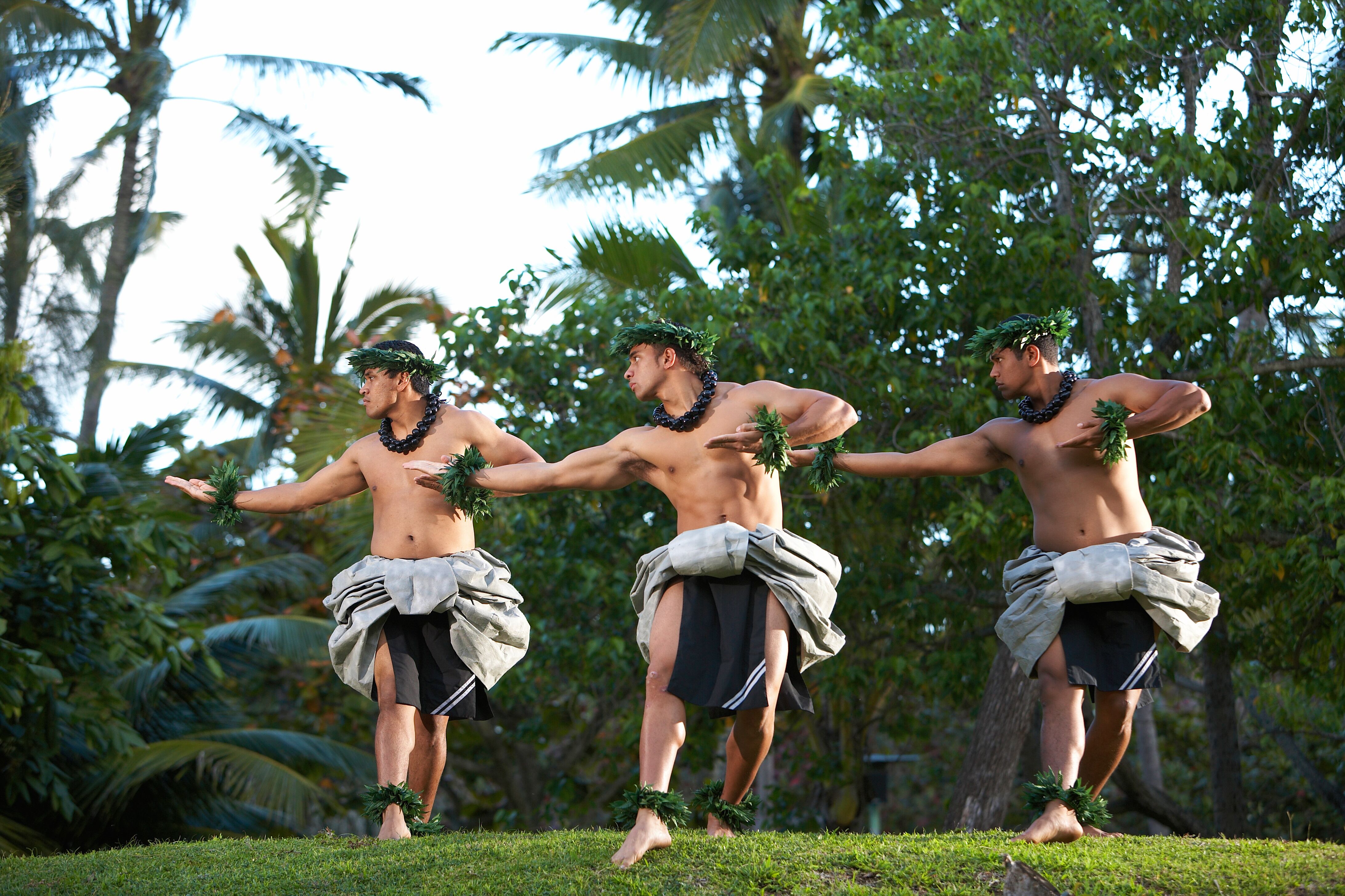 kane (men) performing Hawaiian hula kahiko (ancient hula) at the Polynesian Cultural Center
