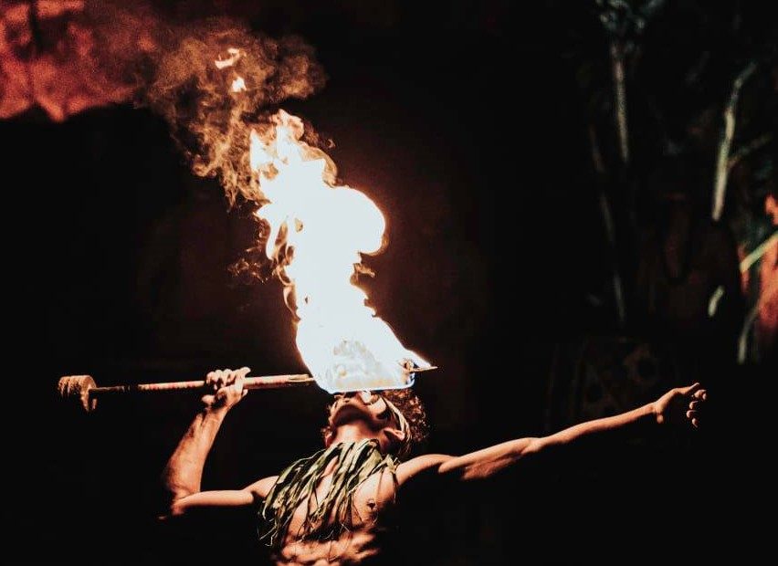 photo showing a competitor from the 28th Annual World Fireknife Competition 'eating fire" at the Polynesian Cultural Center