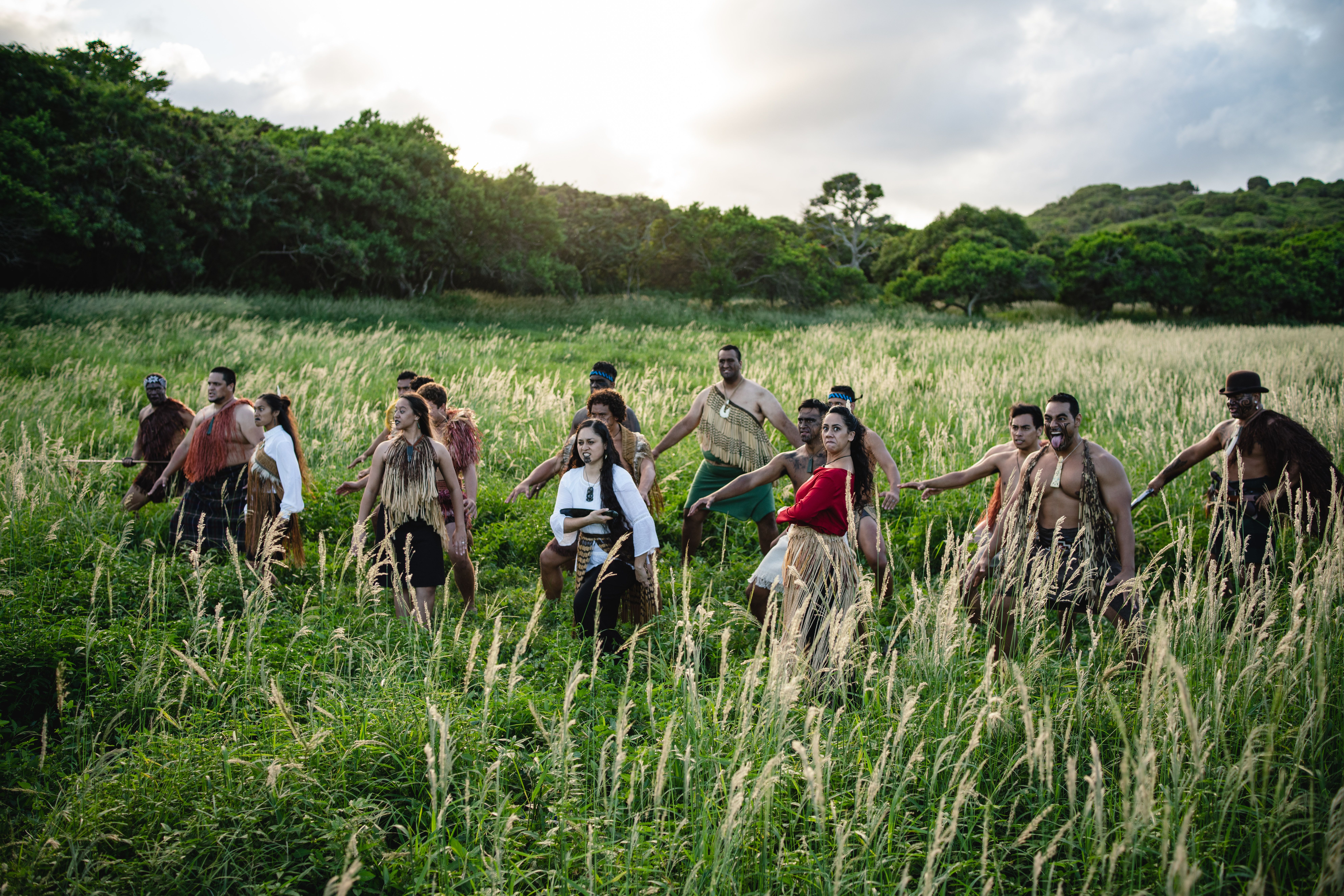 employees from the Polynesian Cultural Center perform Maori Haka in a beautifully lush and green forest landscape