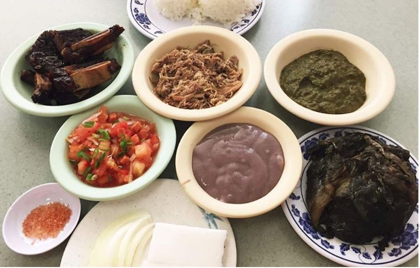 photograph of Hawaiian food; kalua pork, lomilomi, poi, laulau, squid laulau, bbq ribs, rice, Hawaiian red salt, onion