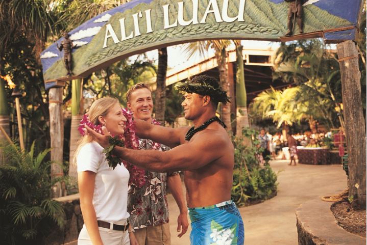 photo of Alii Luau front entrance with a couple welcoming with flower leis