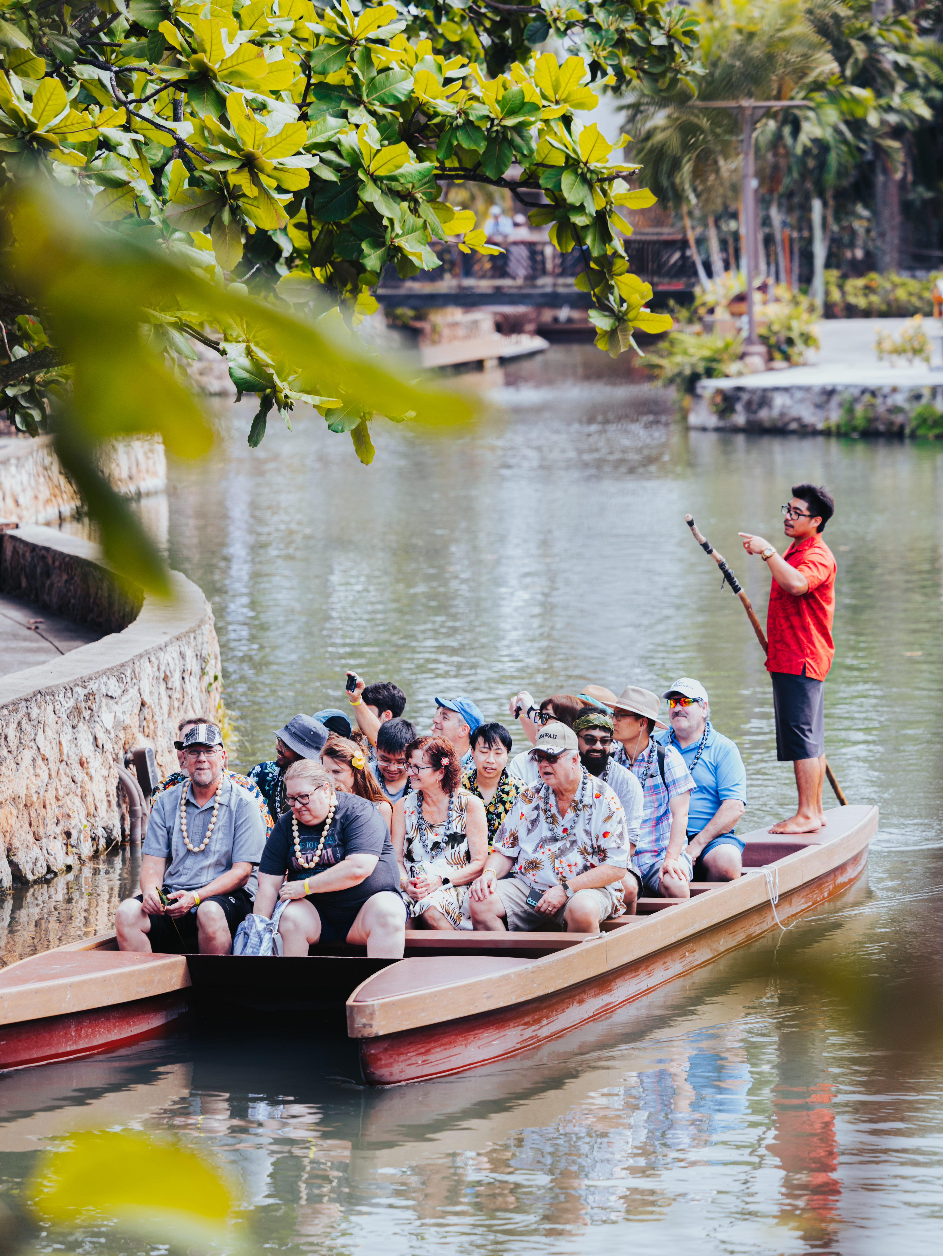 photo of canoe trip with guests and canoe pusher at Polynesian Cultural Center. The secret behind each student performer.