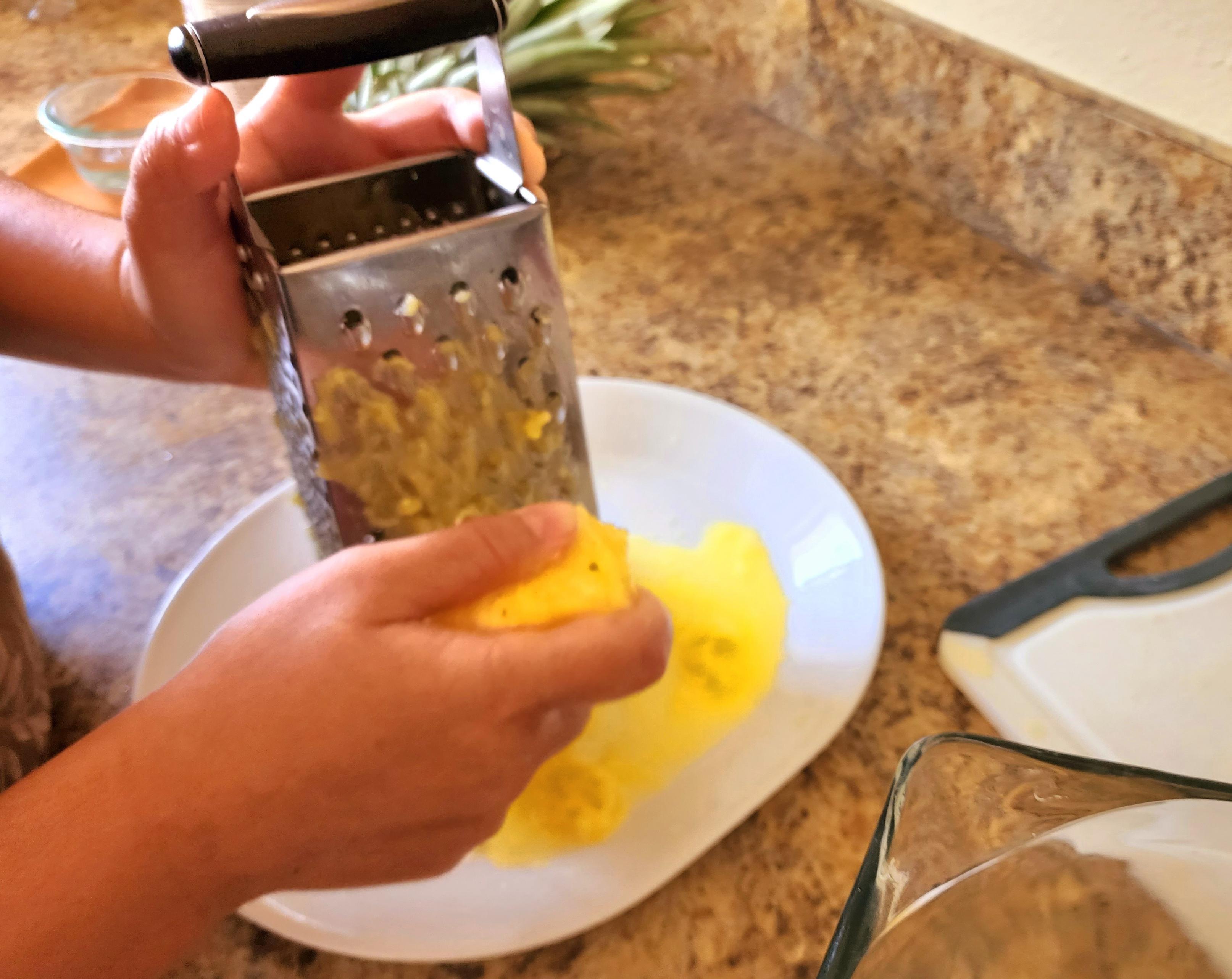 photo of grating the pineapple to make delicious vaifala.