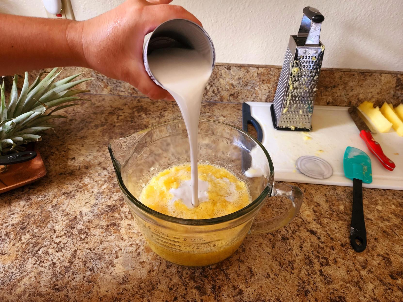 photo of coconut cream added to the grated pineapple. 