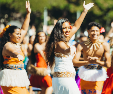 photo of the Center smiling performers during the parade show to celebrate King Kamehameha Day.