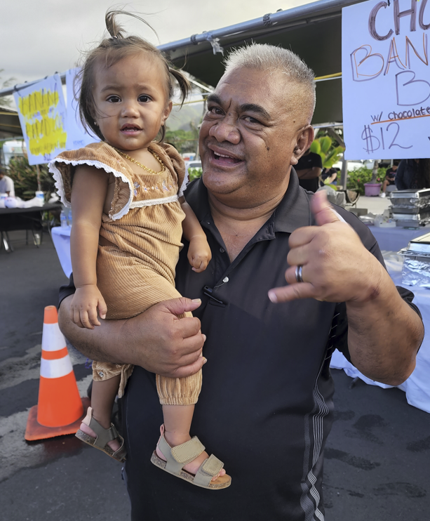 photo William Mahoni and his granddaughter enjoy the 4th of July at Hukilau Marketplace