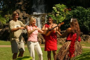 An image of a couple learning hula from the Hawaii village staff at the Polynesian Cultural Center