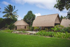 A photo of traditional Hawaiʻi village setting. The huts are the cultural exhibits at the Polynesian Cultural Center. 