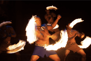 image of Samoan fireknife dancers twirling fireknives at night