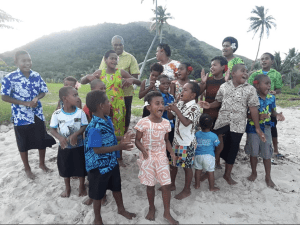 image of Fijian villagers on the beach