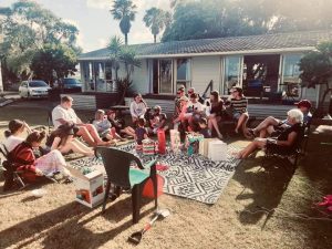 image of the Miller's (Maori family) in the backyard enjoying a Christmas get together