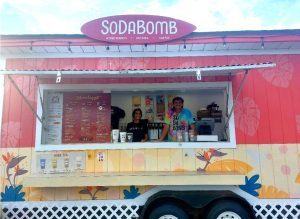 image of SodaBomb truck with two employees posing
