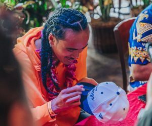 photo of Nico signing autographs at the 2023 Polynesian Football Hall of Fame