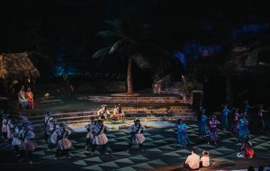 Men and women performing hula kahiko (traditional) style. This is the traditional hula form in Hawaiian culture