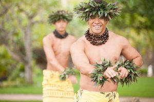 Image of male hula dancers showcase the Hawaiian word Hoʻolauleʻa through the hula movements