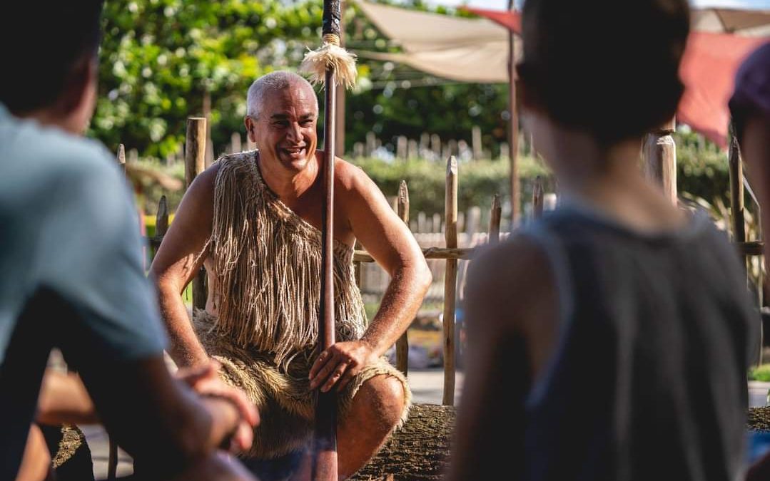 Image of Maori villager at the Polynesian Cultural Center speaking to guests