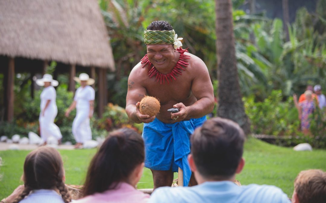 Kap demonstrating coconuts at the Samoan Village