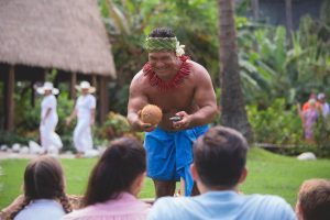 Kap demonstrating coconuts at the Samoan Village