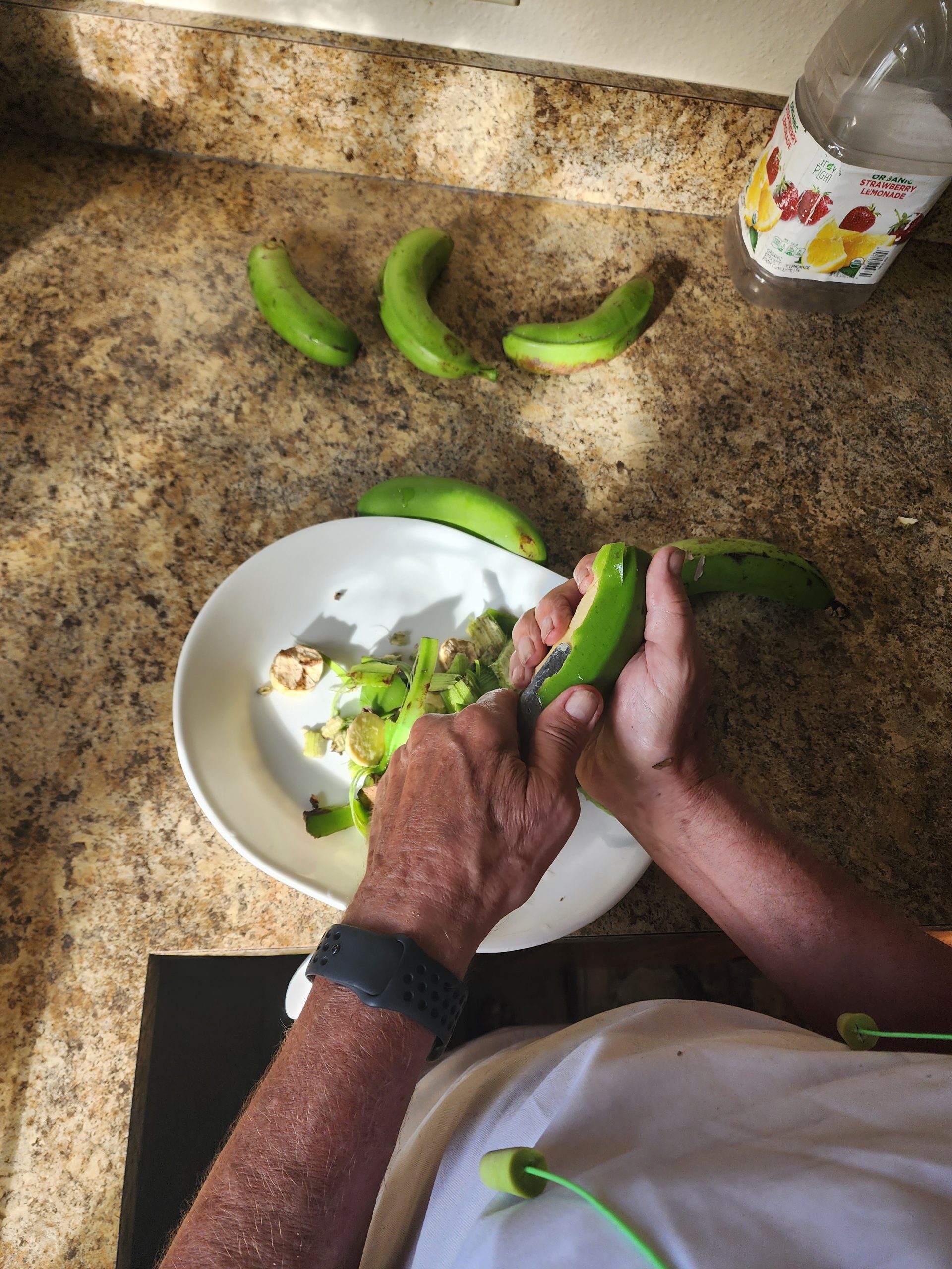peeling green bananas