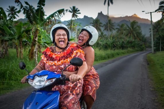 Two Cook island Women on a moped