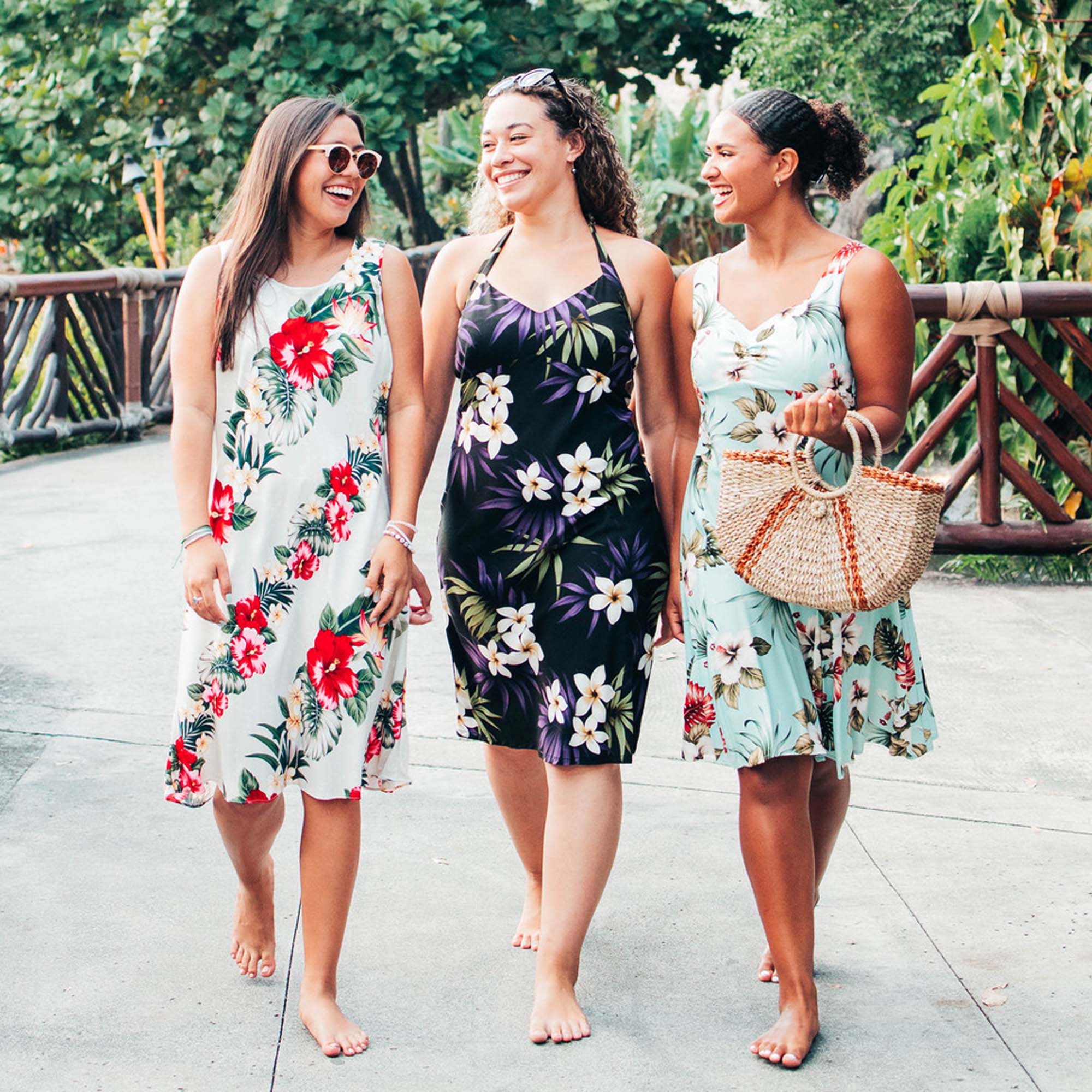 Three ladies wearing Hawaiian apparel.