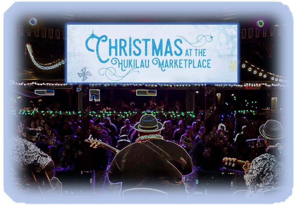 Musician playing his guitar looks out over the crowd as "Christmas at the Hukilau Marketplace" banner hangs above them.