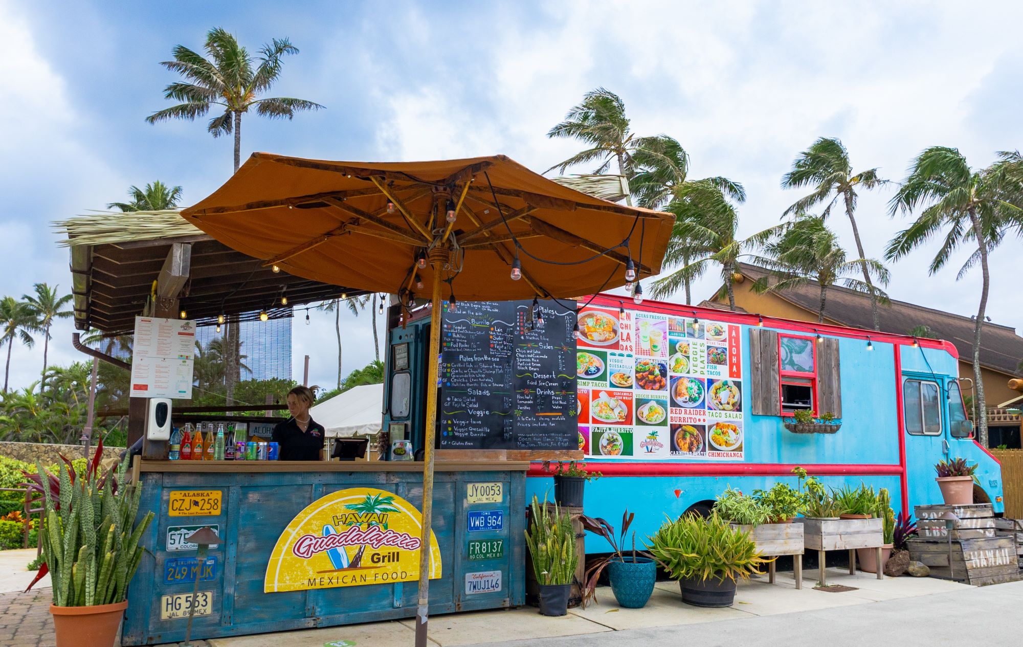 Guadalajara Grill food truck. Bright turquoise blue. Menu is displayed on the side.