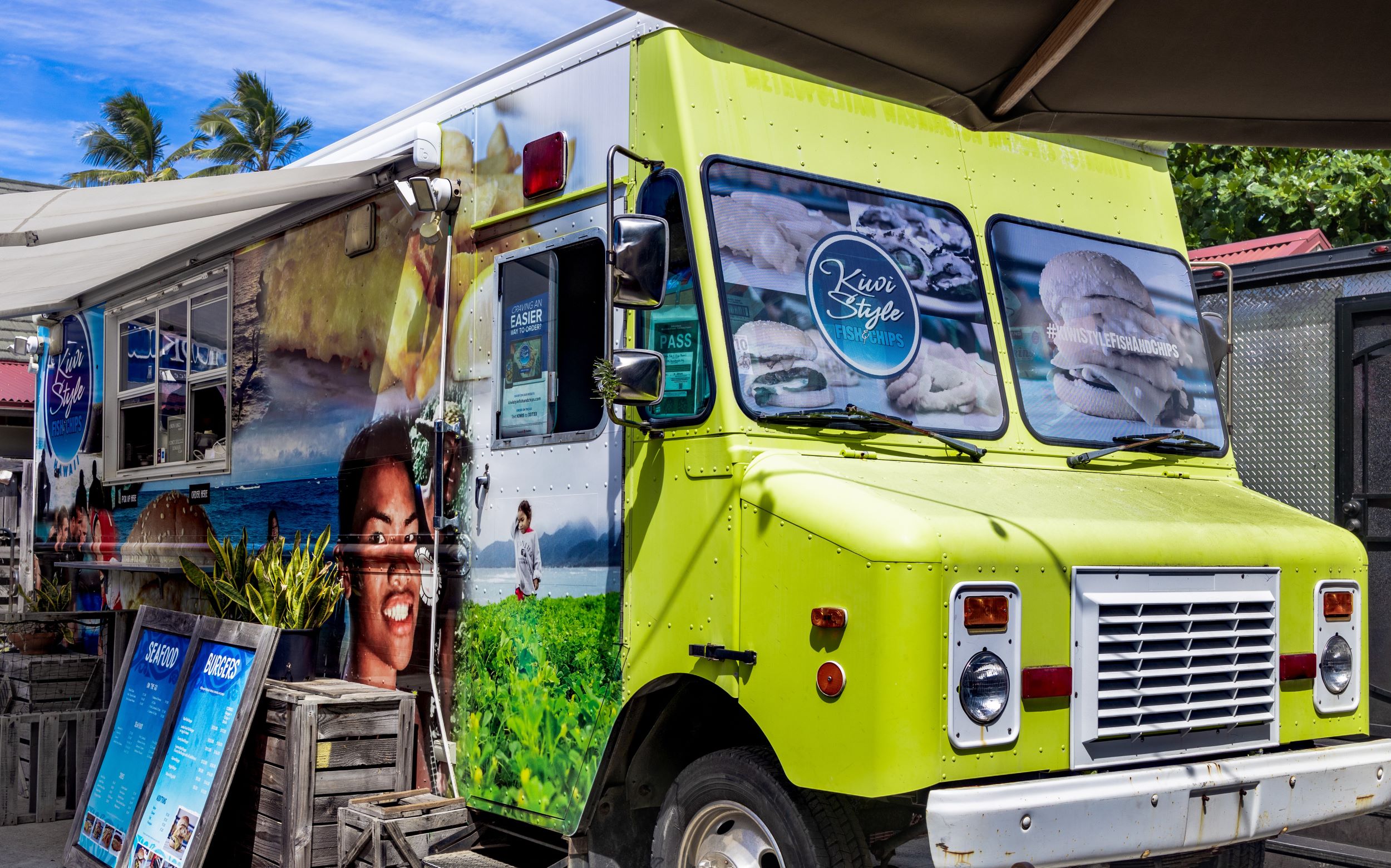 Kiwi Style food truck. Bright chartreuse with New Zealand warrior painted on the front side.