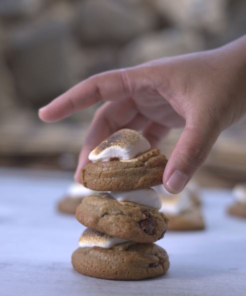 A stack of chocolate chip cookies with toasted marshmallow on the top of each one