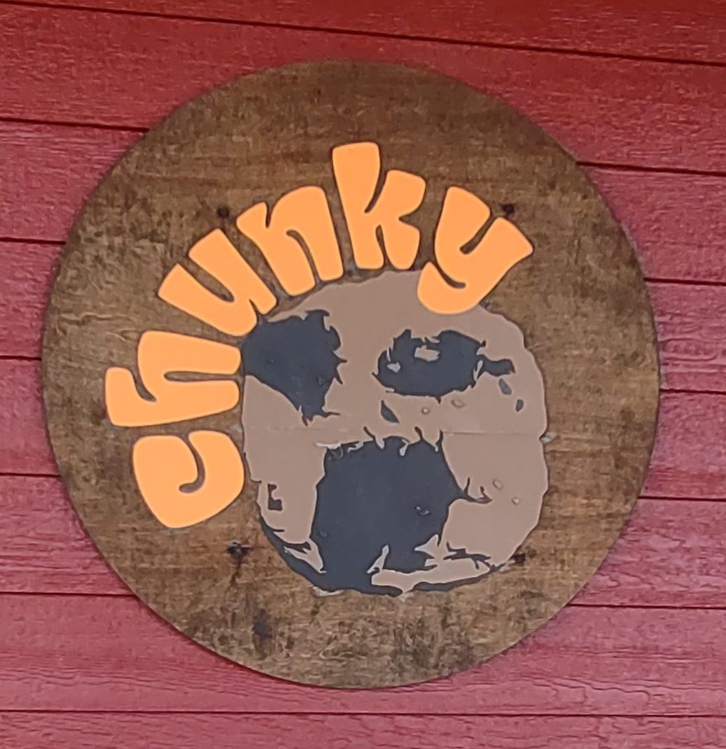 The Chunky Cookie logo, which is a chocolate chip cookie with the work "Chunky" written around the edge