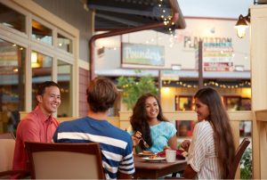 Two couples dining on a restaurant patio