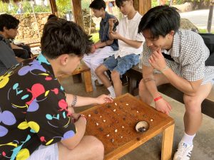 Two guests spend some quiet moments playing konane, a Hawaiian version of checkers.