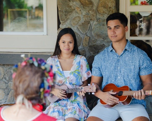 Young man and woman receive a ukulele lesson