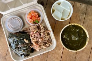 Some Hawaiian dishes like laulau, lomi salmon, kālua pig, haupia and poi.