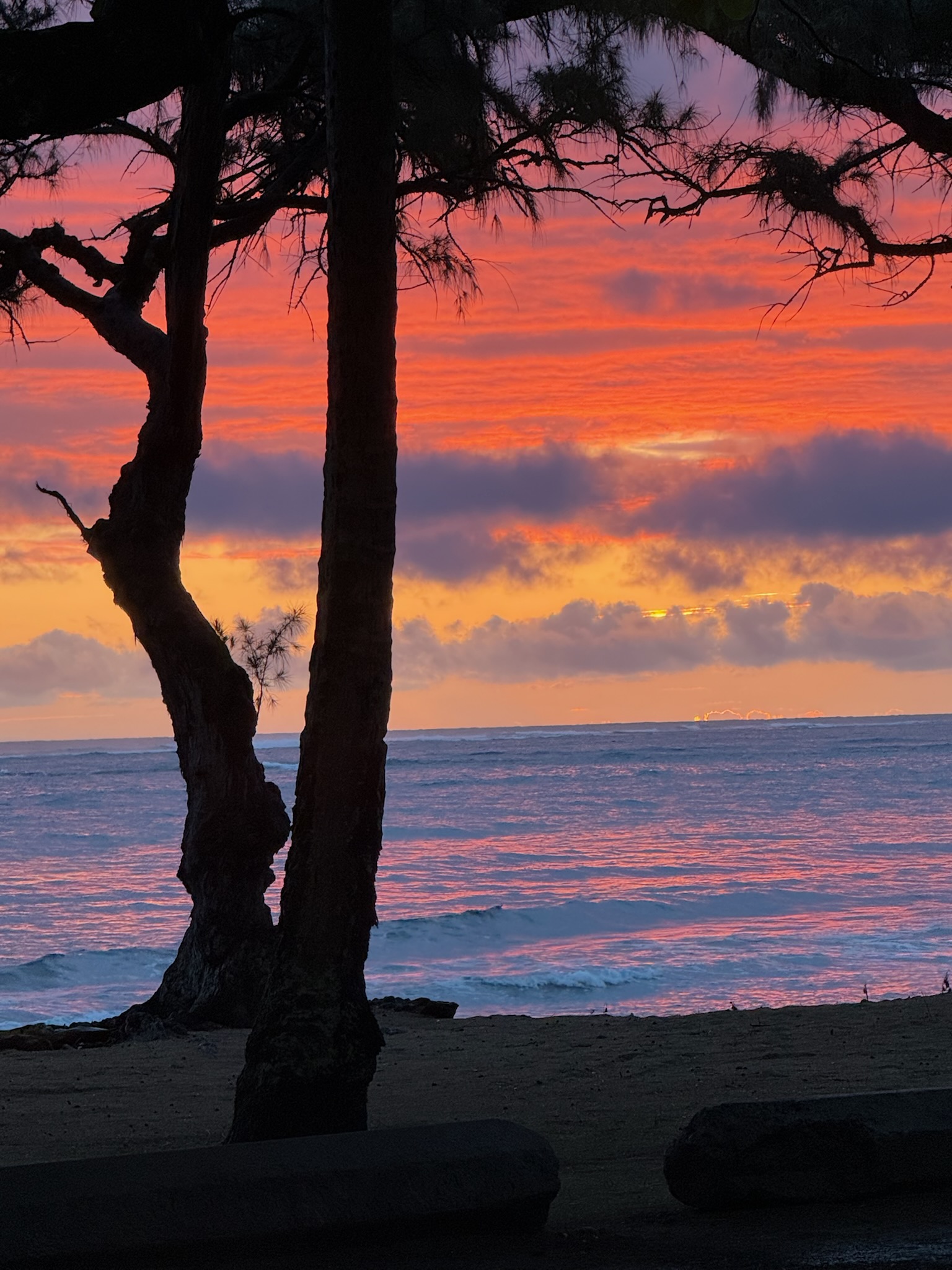 Sunset over the ocean in orange, purple, yellow, pink and blue.