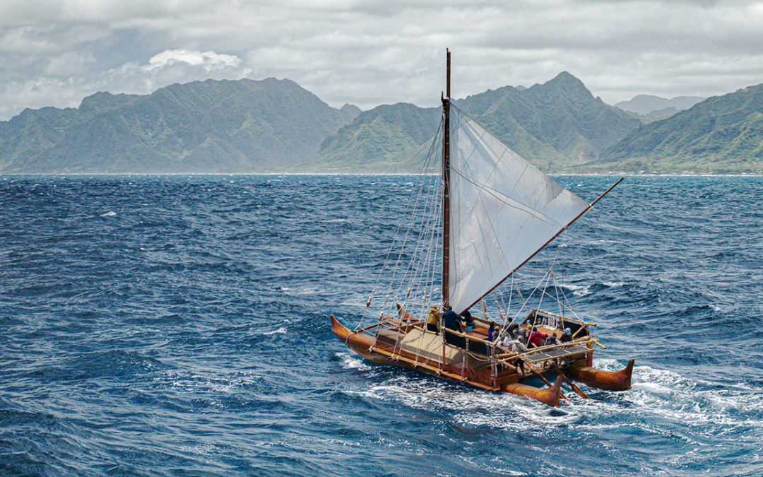 Iosepa, a replica of ancient Polynesian sailing vessels, on the water.