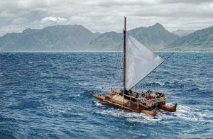 Iosepa, a replica of ancient Polynesian sailing vessels, on the water.